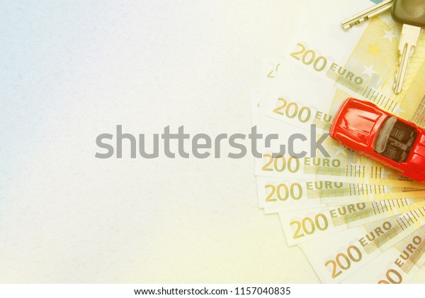 car keys, miniature car, Euro banknotes To\
buy or sell a car, rent a car\
service