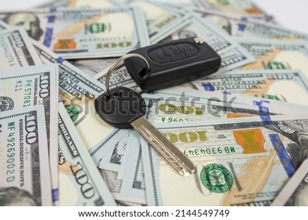 car keys on the background of dollars.modern car key with us dollar, sale or rent concept