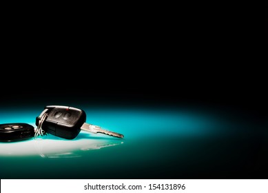 Car Keys On Blue, Reflective Table And Black Background