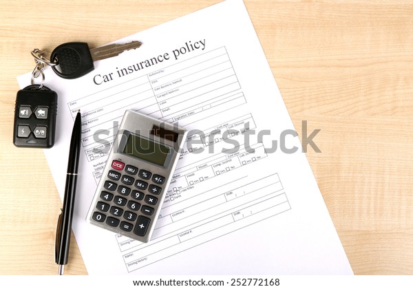 Car keys on
insurance documents, close
up