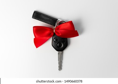 Car Keys With Red Bow As Present On White Background. New Car Gift Concept