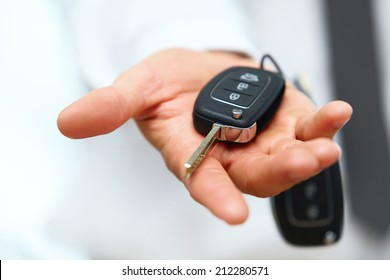 Car Keys. Seller hand giving keys