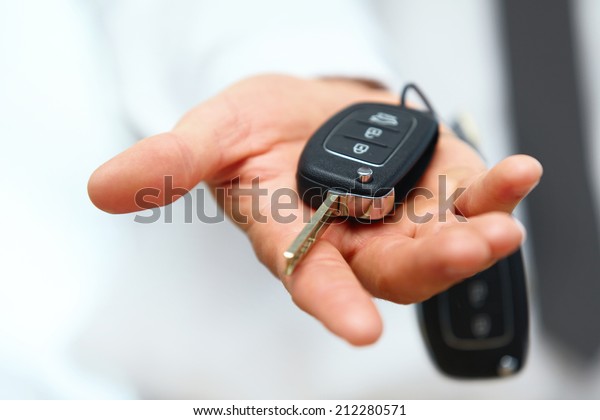 Car Keys. Seller hand
giving keys