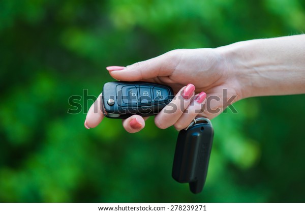 Car Keys. Seller\
woman hand giving keys