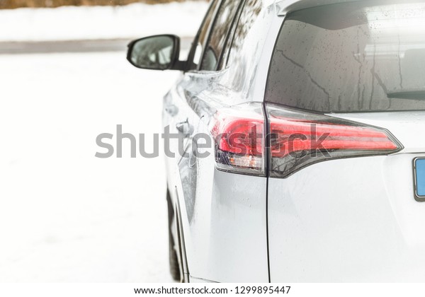 Car lamp\
close-up. Silver SUV Modern electric\
car.
