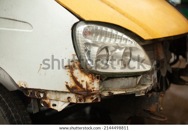 Car lamp. Rusty surface of machine. Old\
transport. Details of average truck in\
Russia.