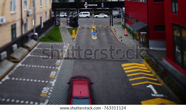 Car leaves the road under the\
barrier. Car left the Parking for the meeting is a road\
barrier
