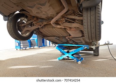 Car Lifted By A Pneumatic Jack Isolated