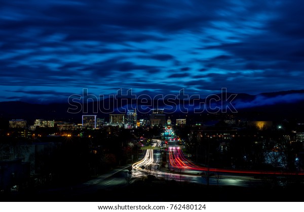 Car light streak down Capital Boulevard early\
morning with the Boise\
Skyline