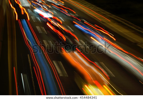 car light\
streaks moving along a highway at\
night