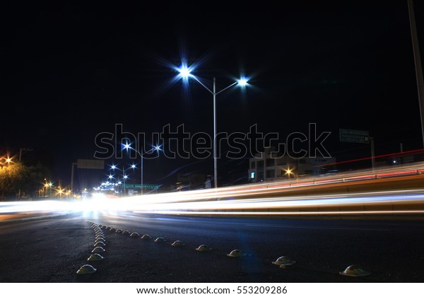 Car light trails and\
bumps in a highway