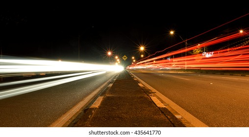 Car Light Trails Coming And Going On An Avenue At Night
