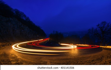 car light trails on a winding road at night in Dilijan, Armenia