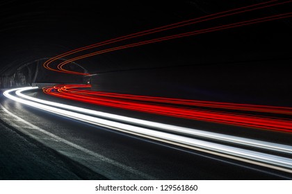 Car light trails in the tunnel. Art image . Long exposure photo taken in a tunnel