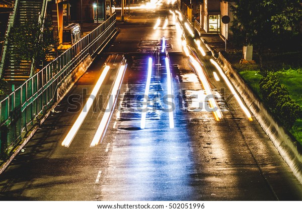 Car lights at night, fast\
moving cars, Blurred car lights, long exposure photo of\
traffic