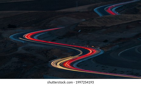 Car Lights At Night On The Mountain Pass Winding Road 