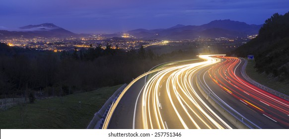 Car Lights At Night On The Road Going To The City, Donostia, Basque Country.