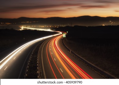 Car Lights At Night On The Road Going To The City
