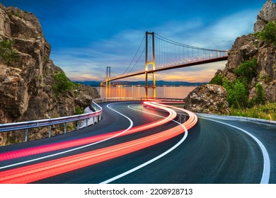 car lights on highway in night journey. Bosphorus bridge in city with evening road landscape. road view in big city. Lights of speeding cars on the big highway in the city traffic. Istanbul, Turkey.