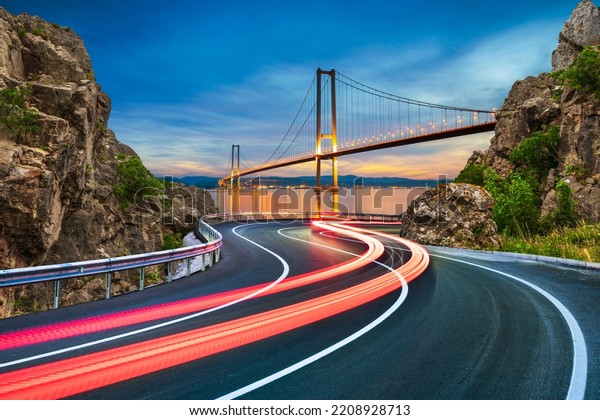 car lights on highway in night journey. Bosphorus\
bridge in city with evening road landscape. road view in big city.\
Lights of speeding cars on the big highway in the city traffic.\
Istanbul, Turkey.