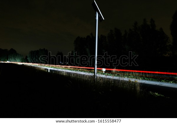 Car lights over a dark\
road