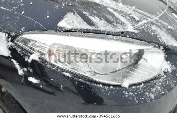 car lights in the snow.Tail light.Ice on the car\
light.Car under the snow