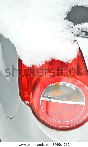car lights in the snow.Tail light.Ice on the car\
light.Car under the snow