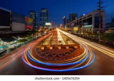 Car Lights With U Turn Road In Sutthisan District With Architecture Buildings In Transportation Concept. Urban City, Bangkok At Night, Thailand.