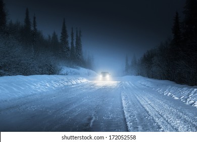 Car lights in winter Russian forest
