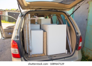 car loaded with furniture stands on the street - Shutterstock ID 1089647129