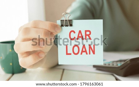 Car loan concept with text, calculation for debt repayment.