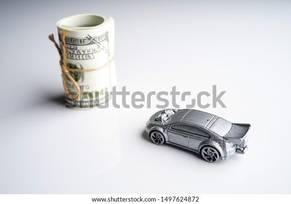 Car
loan, Insurance, buy and sell and Auto Finance conceptual image
with Car Key remote, die cast car and dollar bills
