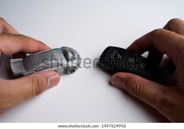 Car\
loan, Insurance, buy and sell and Auto Finance conceptual image\
with Car Key remote, die cast car and dollar bills\
