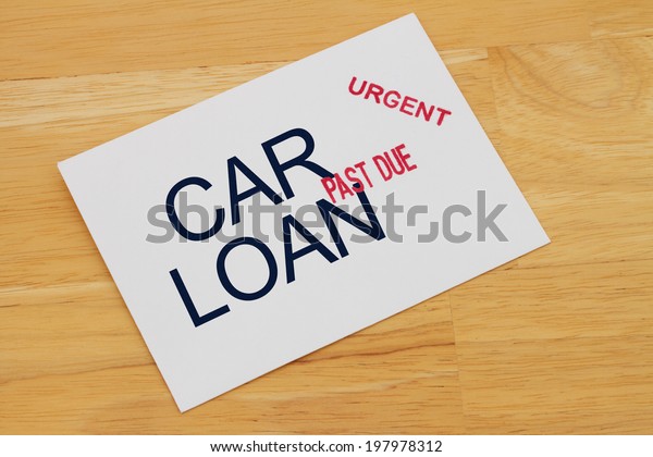 Car Loan Payment Past Due envelop with past\
due and urgent stamps on a wooden\
desk