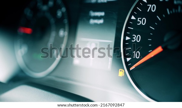 Car low\
fuel level indicator light, close-up\
shot