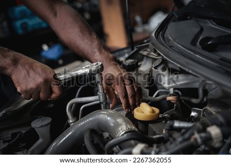 Car Machanic checking and maintenance on the car in the garage. Car repair and maintenanc concept. 