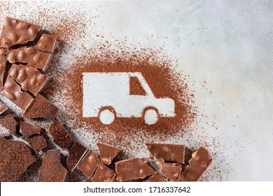 Car made of cocoa powder and chocolate on a light background. Online shopping. Concept of delivery services, logistics, cargo delivery. Copy space