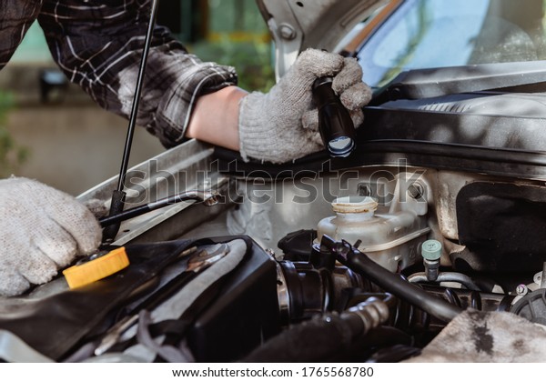 Car\
maintenance. Men at work from home. Auto mechanic repair engine.\
Social distancing and New normal\
lifestyle.