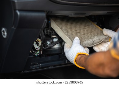 Car maintenance and repair concept. Man removing the dirty car air conditioner filter for cleaning or replace. close up shooting - Shutterstock ID 2253808965