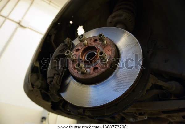 \
Car maintenance series: Closeup of car disc\
brake. Maintenance and repair of the car in a modern technical\
center.                              \
