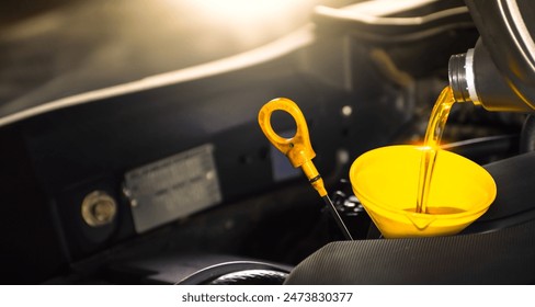 Car maintenance service , Pouring engine oil into a funnel for engine maintenance include a oil dipstick for oil level measurement , copy space , Car repair garage business concept - Powered by Shutterstock