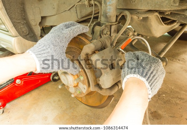 Car\
maintenance service, Use 8 mm. Wrench to change brake fluid. Auto\
mechanic check and maintenance brake\
system.