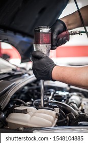 Car master mechanic repairer checking, testing and changing spark plugs on the car in auto vehicle workshop - Shutterstock ID 1548104885