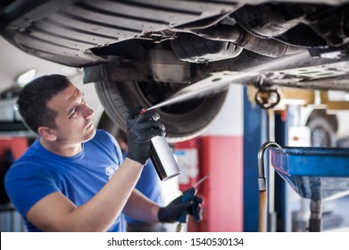 Car Master Mechanic Repairer Lubricates The Screws With A Machine Parts Cleaner Oil Dirt Grease Aerosol Spray For Lubrication In Auto Vehicle Workshop