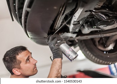 Car Master Mechanic Repairer Lubricates The Screws With A Machine Parts Cleaner Oil Dirt Grease Aerosol Spray For Lubrication In Auto Vehicle Workshop