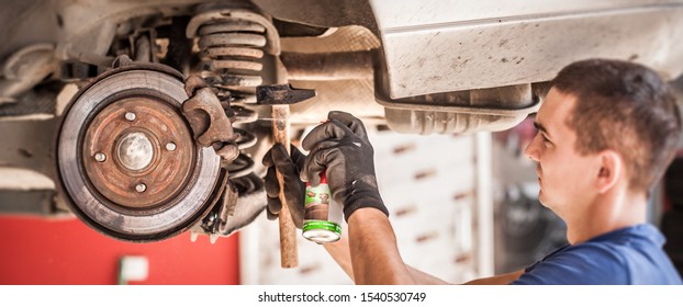 Car Master Mechanic Repairer Lubricates The Screws With A Machine Parts Cleaner Oil Dirt Grease Aerosol Spray For Lubrication In Auto Vehicle Workshop