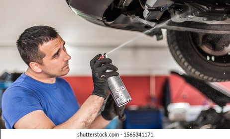 Car Master Mechanic Repairer Lubricates The Screws With A Machine Parts Cleaner Oil Dirt Grease Aerosol Spray For Lubrication In Auto Vehicle Workshop