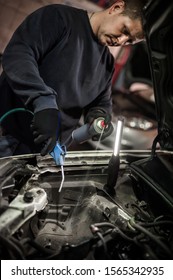 Car Master Mechanic Repairer Lubricates The Screws With A Machine Parts Cleaner Oil Dirt Grease Aerosol Spray For Lubrication In Auto Vehicle Workshop