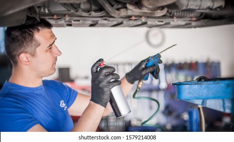 Car Master Mechanic Repairer Lubricates The Screws With A Machine Parts Cleaner Oil Dirt Grease Aerosol Spray For Lubrication In Auto Vehicle Workshop