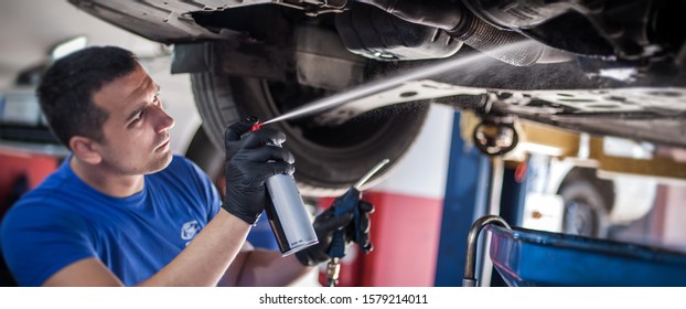 Car Master Mechanic Repairer Lubricates The Screws With A Machine Parts Cleaner Oil Dirt Grease Aerosol Spray For Lubrication In Auto Vehicle Workshop